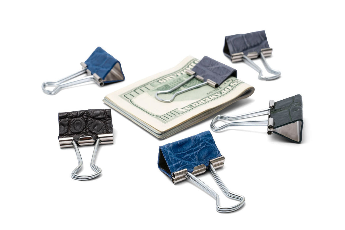 The Mahoney Clip genuine matte alligator money clip, handcrafted in America, shown in various colors on a white background.