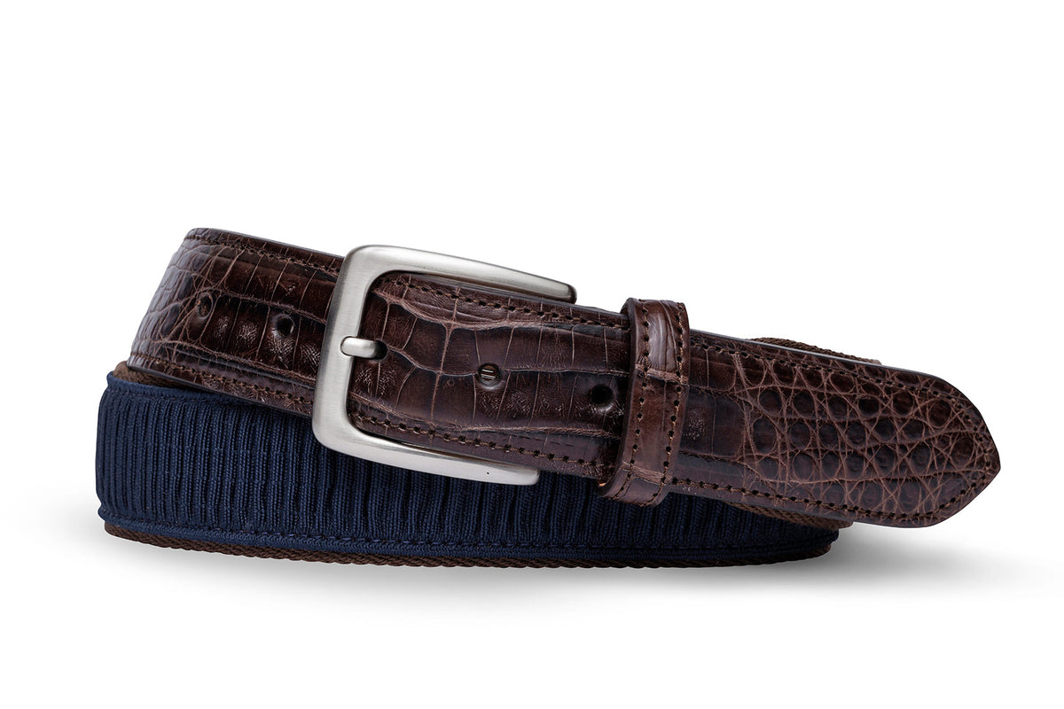 w.kleinberg blue ribbon belt with crocodile tabs and brushed nickel buckle flat lay